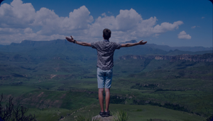 man with open arms looking towards horizont demonstrating CPLs Aspiration: Individual Freedom